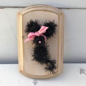 Crocheted tiny mouse on a wood plaque